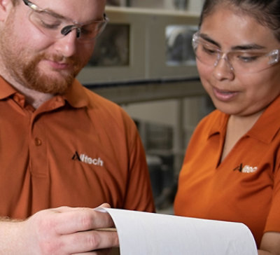 A man and woman looking at a piece of paper.