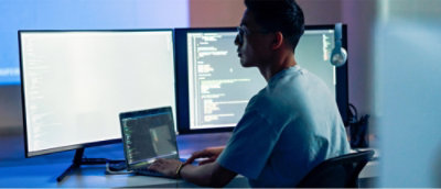 a man sitting at a desk with a laptop