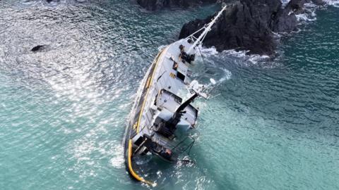 A shipwreck is seen from a bird's eye view.