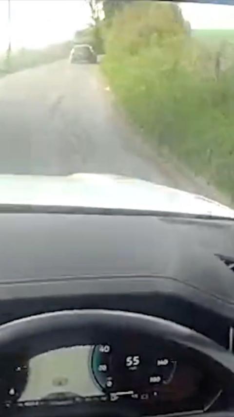 Car in the distance seen through another vehicle windscreen 