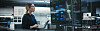 A QA engineer works through a project on a large screen in an office