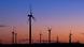 Windmills rotate as the sun sets Windmills rotate as the sun sets