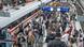 A train and crowds at a station A train and crowds at a station